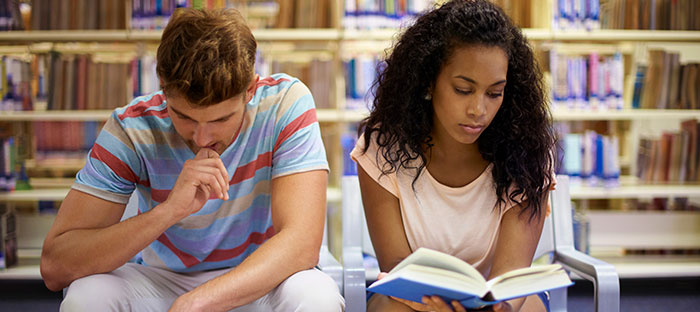 2 students sitting in library