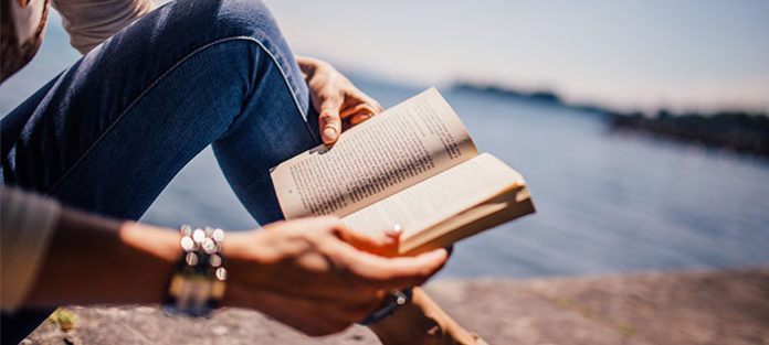 Person-reading-a-book-outside