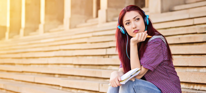Female student sitting on stairs