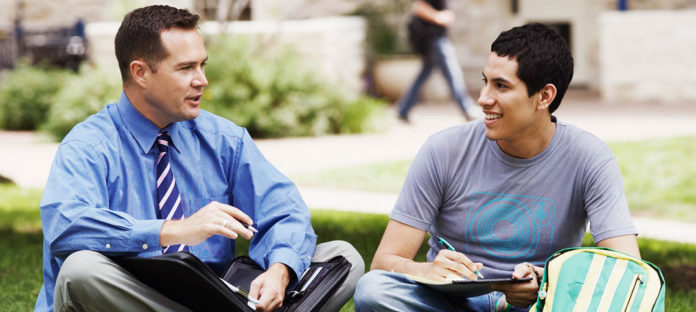 Student and teacher talking outside