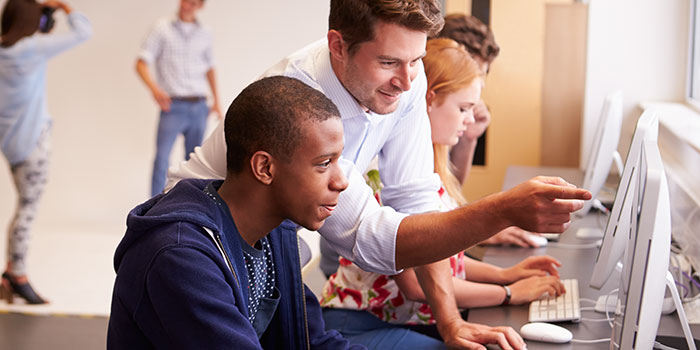 Teacher and student at computer