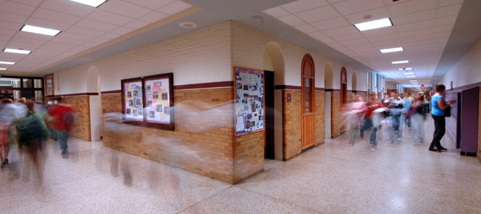 1216_shooting_featureimg Busy school hallway and exit sign