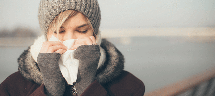 Girl blowing her nose