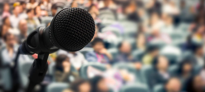 Microphone in front of blurry crowd