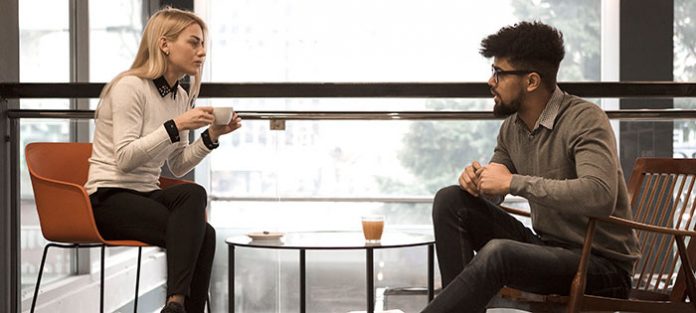 Two friends talking over coffee