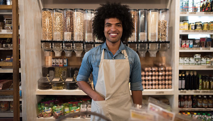 Young store clerk smiling at camera