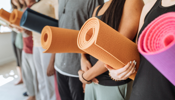 yoga class holding mats