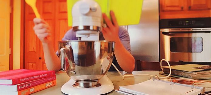 Person-cooking-using-a-cookbook Person-cooking-using-a-cookbook