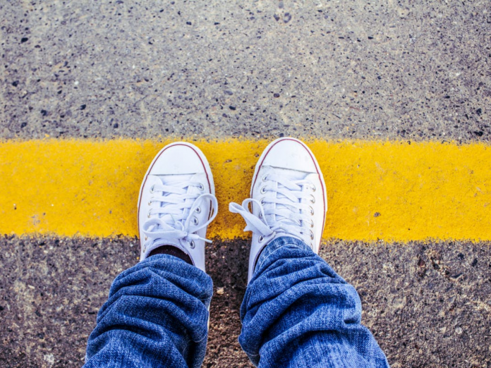 Feet on yellow road line