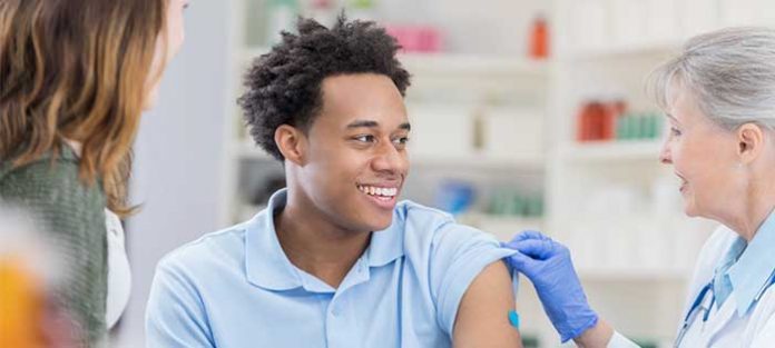 Two-college-students-getting-flu-shots Two college students getting flu shots