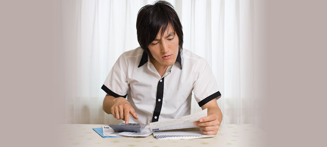 Young male balancing checkbook