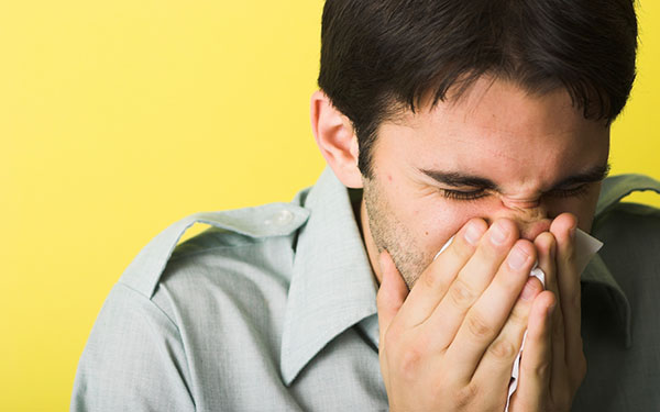 allergies man sneezing