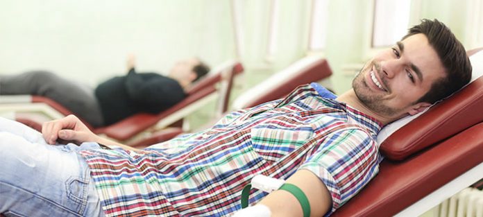 Male-college-student-getting-his-blood-taken Male-college-student-getting-his-blood-taken