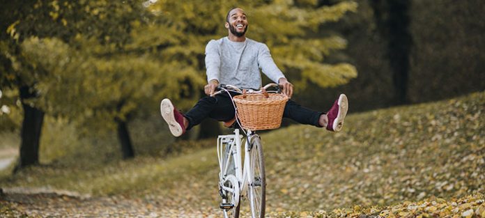 happy male cruising on bike