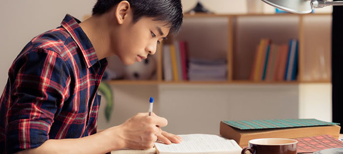 Asian boy studying at desk
