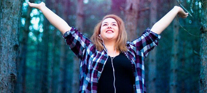 Girl with her arms raised