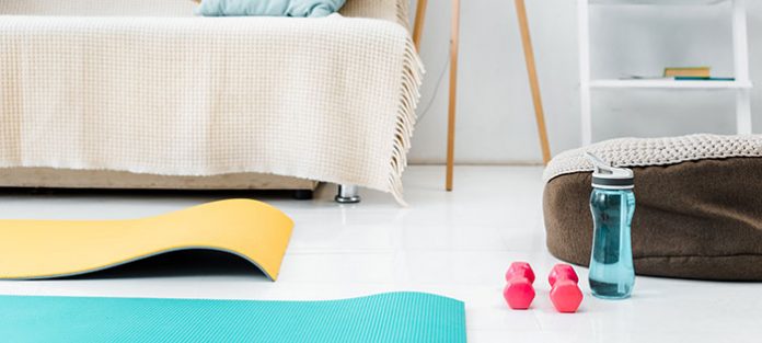Yoga mat, weights, water bottle in living room