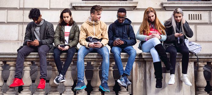 students looking down at phones