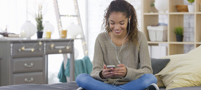 Teen enjoying time at home on smart phone