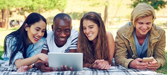 Group of students on computer and phone