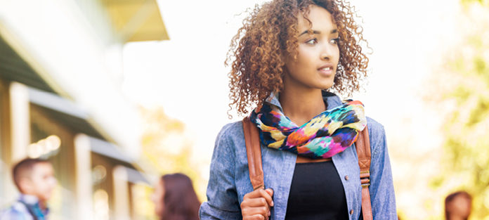 African American female walking on campus