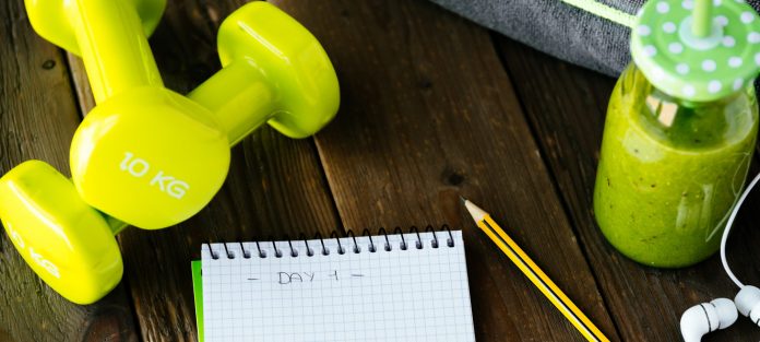 dumbbells and notepad