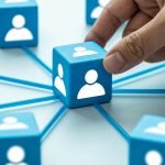 Why every student needs a LinkedIn profile - 6 reasons to start now Hand placing connected profile blocks representing professional networking and connections