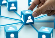 Why every student needs a LinkedIn profile – 6 reasons to start now Hand placing connected profile blocks representing professional networking and connections