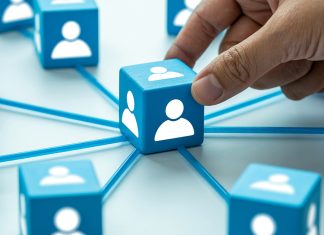 Why every student needs a LinkedIn profile – 6 reasons to start now Hand placing connected profile blocks representing professional networking and connections