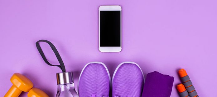 Workout gear and a cell phone on a purple background