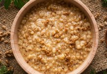 UCookbook: Savory oatmeal with garlicky greens Bowl of savory oatmeal topped with grains and spices on rustic table