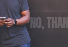 Sexting with sense: How to keep it safe, smart, and respectful Man texting on his phone, with large faded words reading “NO, THANKS!” behind him.