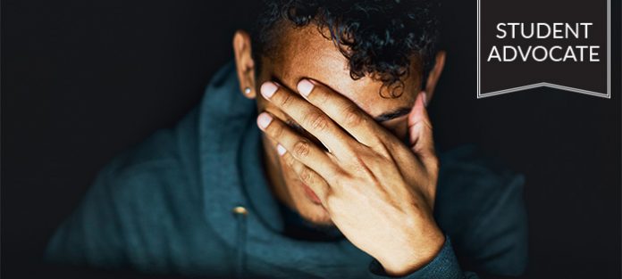 Student Advocate: male in dark covering face