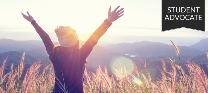 Student advocate: Girl with hands in air