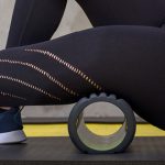 What an active rest day looks like and why it matters closeup of woman foam rolling leg | active rest day workout