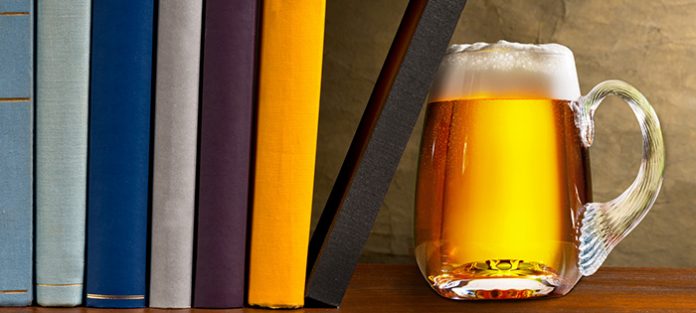 mug of beer and stack of books
