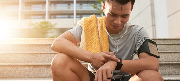 male looking at fitness watch