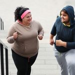 Ask the trainer: “How does a plus-size person start working out?” overweight friends exercising on stairs | what workout is recommended for plus size
