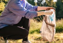 woman picking up trash on run | plogging