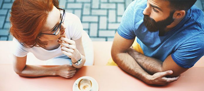 man and woman talking over coffee