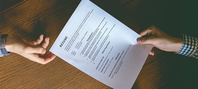 resume being passed between two people