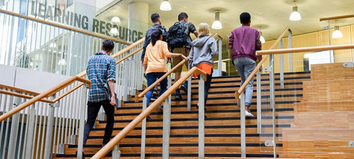 students climbing stairs to resource center
