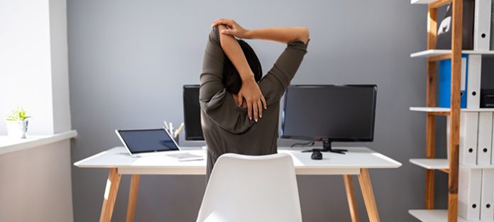 female stretching at desk