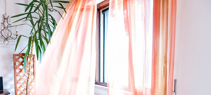 orange curtains in breezy window | tips to stop worrying