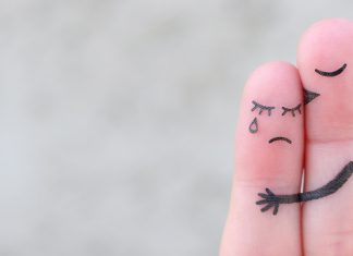 Ask the counselor: How do I know if my partner’s dependency is unhealthy? Two fingers hugging, one sad and one comforting, representing emotional support and dependency