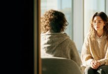 Want to communicate better? Start with active listening Two people sit facing each other in conversation, suggesting attentive listening, empathy, and meaningful communication.