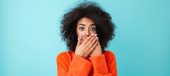 Black woman covering mouth | vaping and oral health