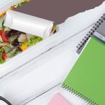 Ask the nutritionist: “I skip meals sometimes because my schedule is so busy. Is that bad for my body?” Healthy salad on a desk with notebooks and pens, symbolizing study and nutrition balance.