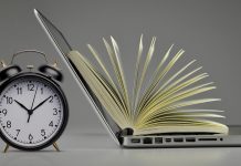 Alarm clock, laptop, and open book showing balance between time management and online learning.