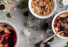 UCookbook: A warm & wintry apple blackberry crisp Apple and blackberry crisp in small bowls with oatmeal topping, surrounded by scattered oats and berries.